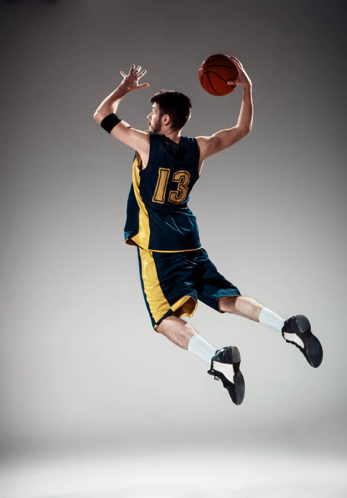 Full length portrait of a basketball player with ball