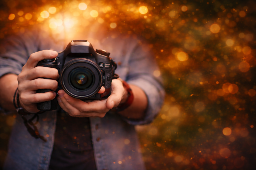 a man holds a camera in golden hour looks like beginners tutorial image